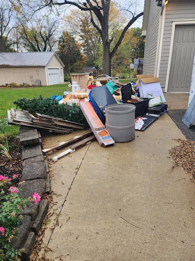 Dumpster being loaded with debris for Estate Cleanout Dumpster Rental in Barton Creek